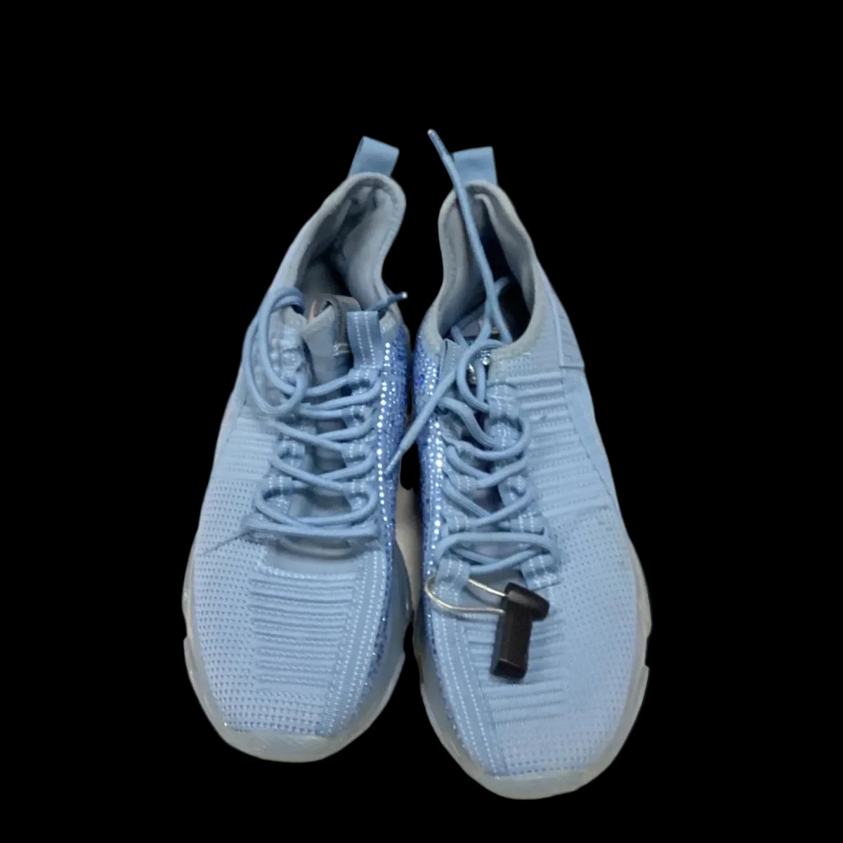 A pair of light blue knit athletic sneakers with matching laces, shown from a top-down view against a solid black background.