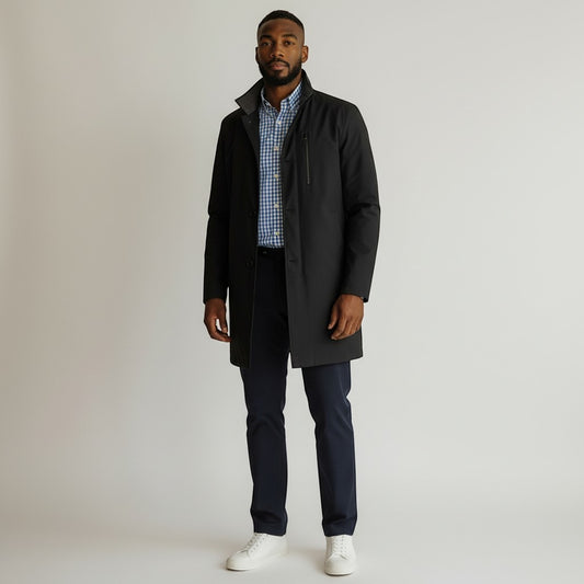 The Xchange model wearing a deep blue John W. Nordstrom Preston raincoat over a blue gingham shirt and navy trousers.