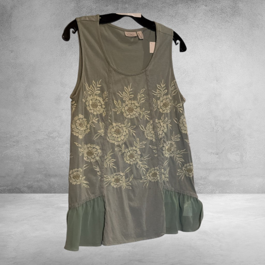 The Xchange LOGO sage green sleeveless tank top with cream floral embroidery, scoop neck, and sheer ruffled hemline.