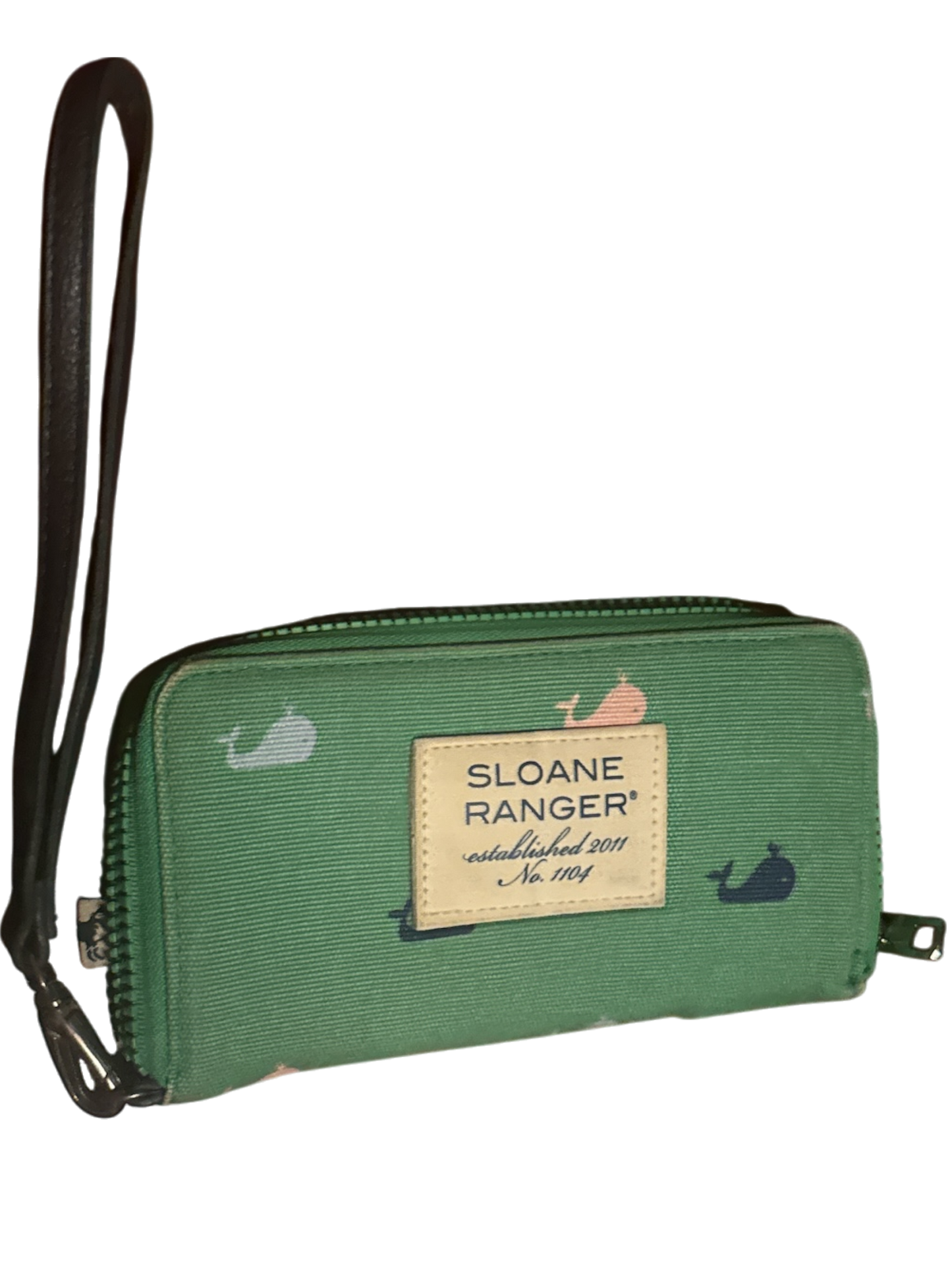 The Xchange Sloane Ranger green canvas wallet with a whale print and wrist strap.