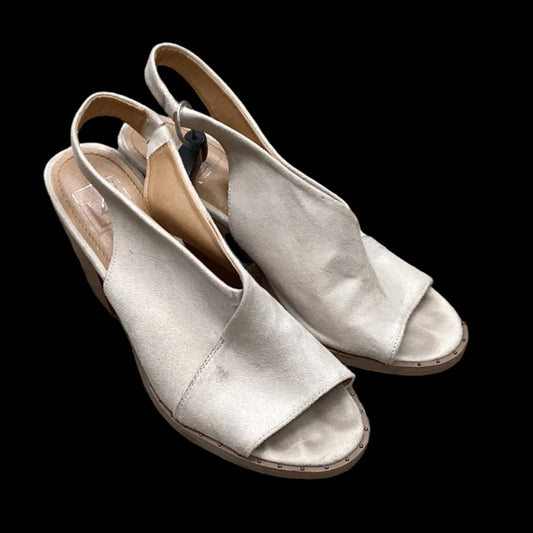 Pair of silver sandals on a black background