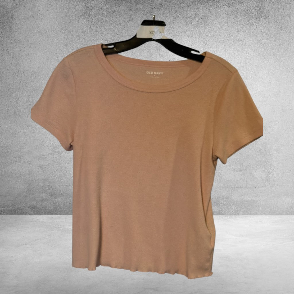 The Xchange Old Navy peach ribbed crew neck t-shirt with short sleeves and a lettuce-edge hem on a hanger.