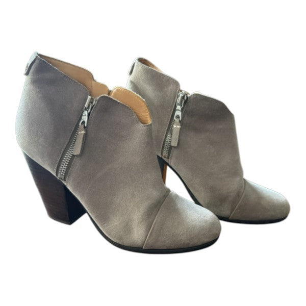 The Xchange taupe suede ankle booties featuring a V-cut topline, side zipper, and a sturdy stacked block heel.