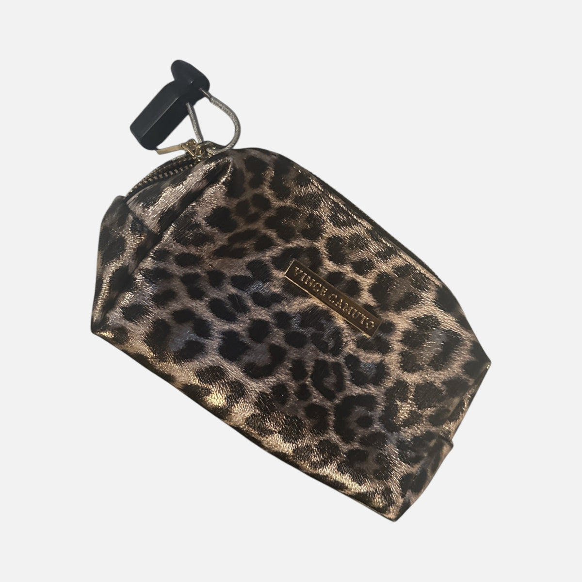 The Xchange Vince Camuto small makeup bag in a metallic leopard print with a gold logo plate and secure zip closure.