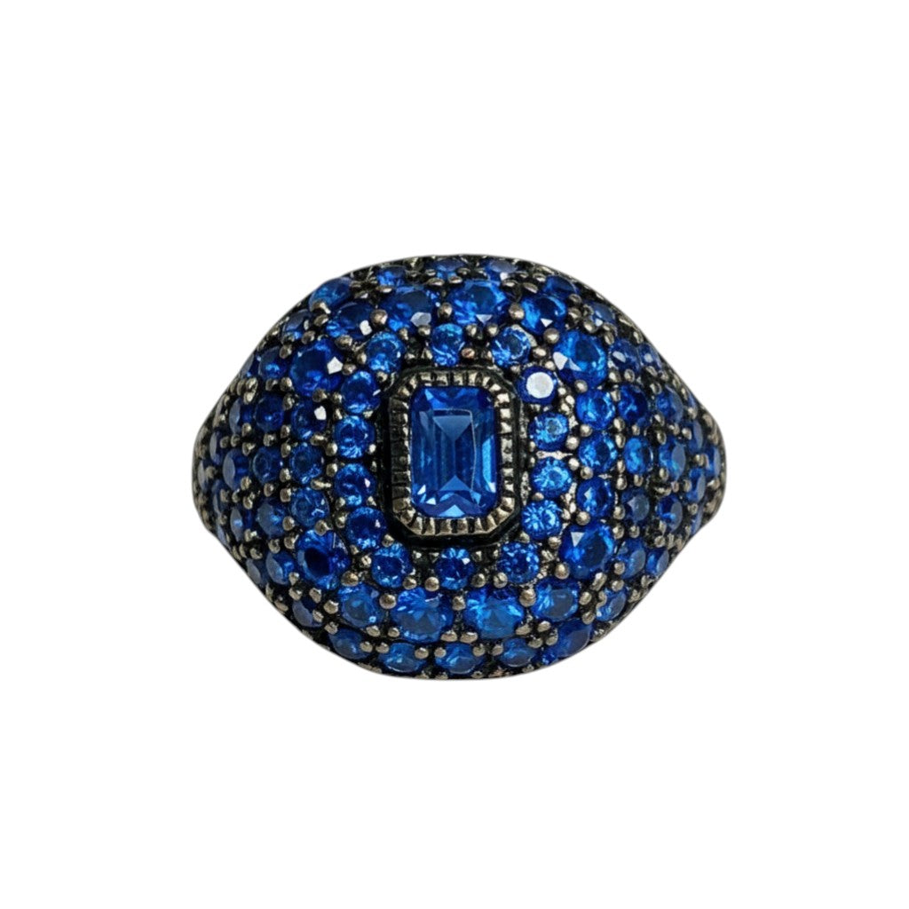 The Xchange Barzel women's size 5 ring with blue crystals and 18k gold plating. Features a central rectangular blue stone surrounded by smaller blue crystals.