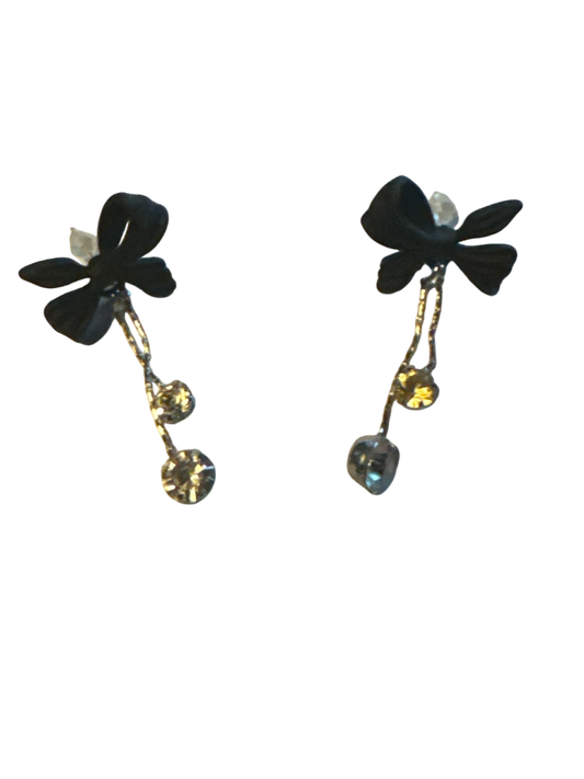 The Xchange black bow statement earrings with silver chain and crystal drop accents.