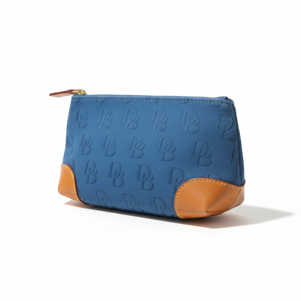 The Xchange Dooney & Bourke blue canvas small tote with tan leather trim and embossed DB logo pattern.