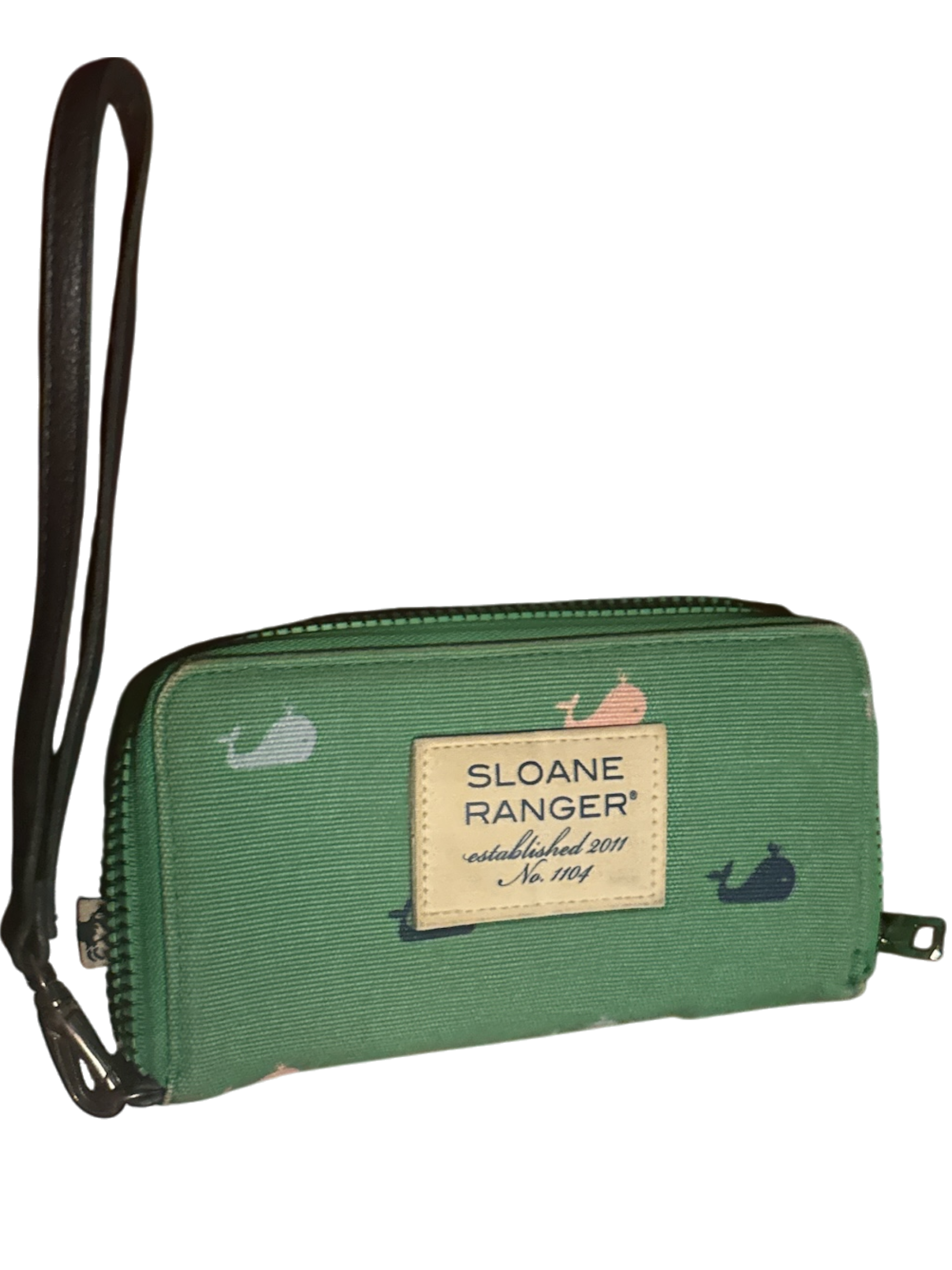 The Xchange Sloane Ranger green canvas wallet with a whale print and wrist strap.