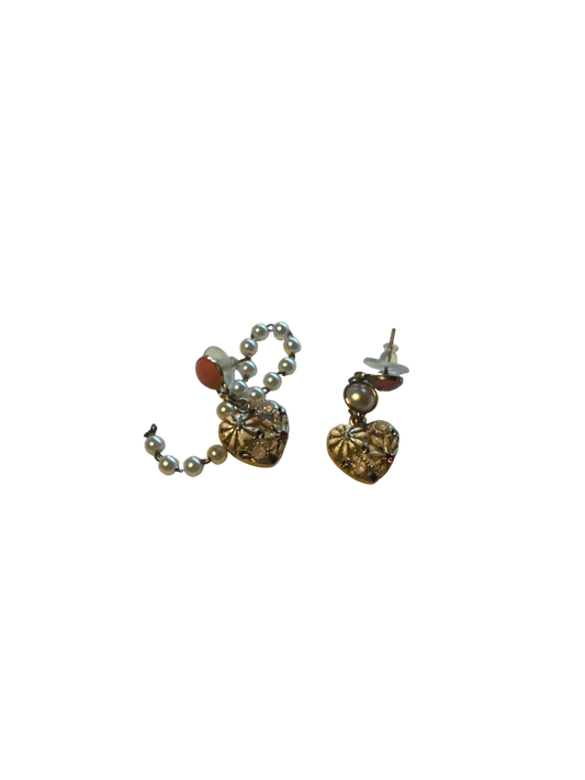 The Xchange pink and gold heart-shaped seashell earrings with pearl accents and small red gems.